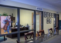 Floor to ceiling windows looking into the Executive Director's office.